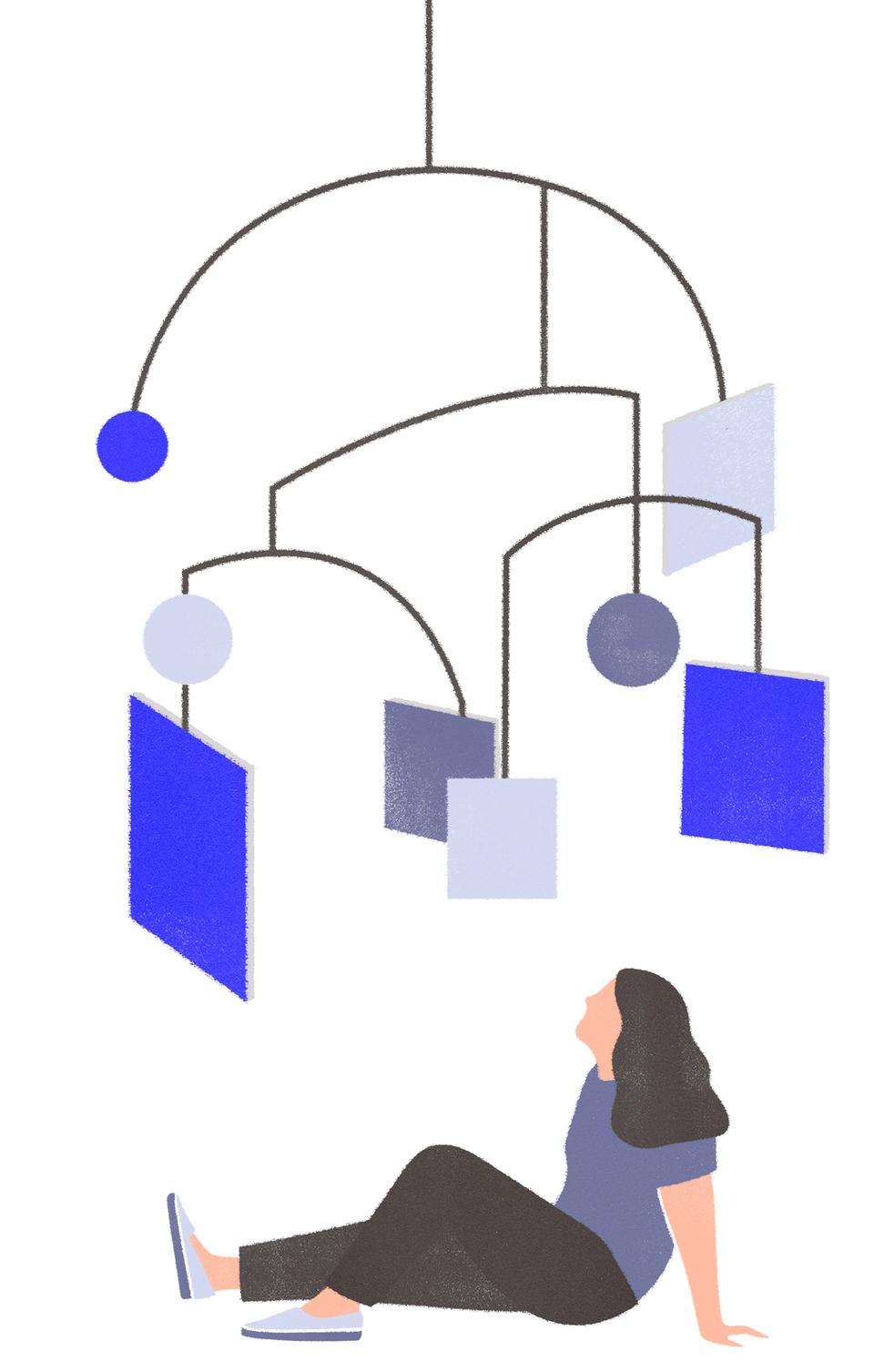 Woman sitting under mobile of different shapes representing blockchain technology and information
